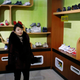 In this Friday, Feb. 1, 2019, photo, a guide stands in a product exhibition room at Ryuwon Shoe Factory that specializes in sports footwear, in Pyongyang, North Korea. North Korean pop culture, long dismissed by critics as a kitschy throwback to the dark days of Stalinism, is getting a major upgrade under leader Kim Jong Un. The changes are being seen in everything from television dramas and animation programs to the variety and packaging of consumer goods, which have improved significantly under Kim. (AP Photo/Dita Alangkara)